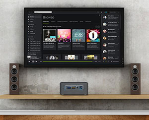 Intel NUC placed on a shelf underneath a TV